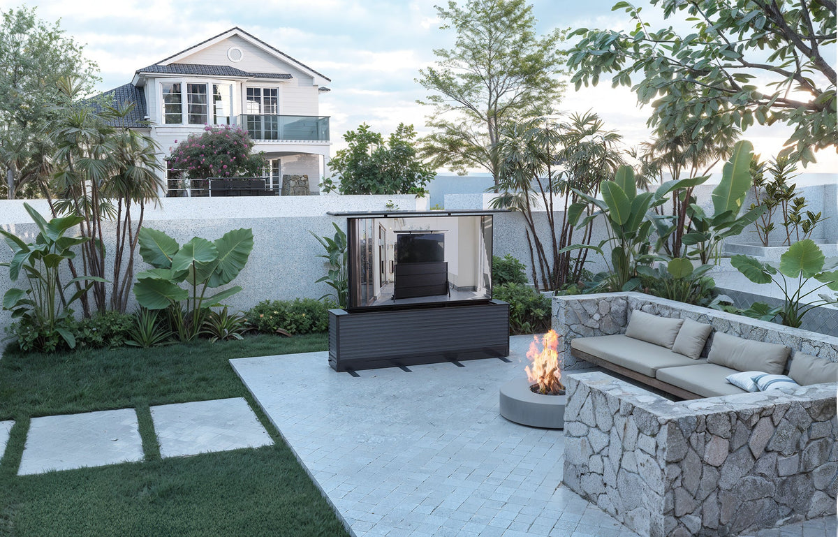 Outdoor TV lift cabinet in a landscaped backyard