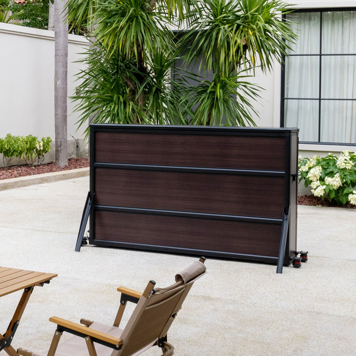 IntelliCube 65-inch weatherproof outdoor TV lift cabinet installed on a patio