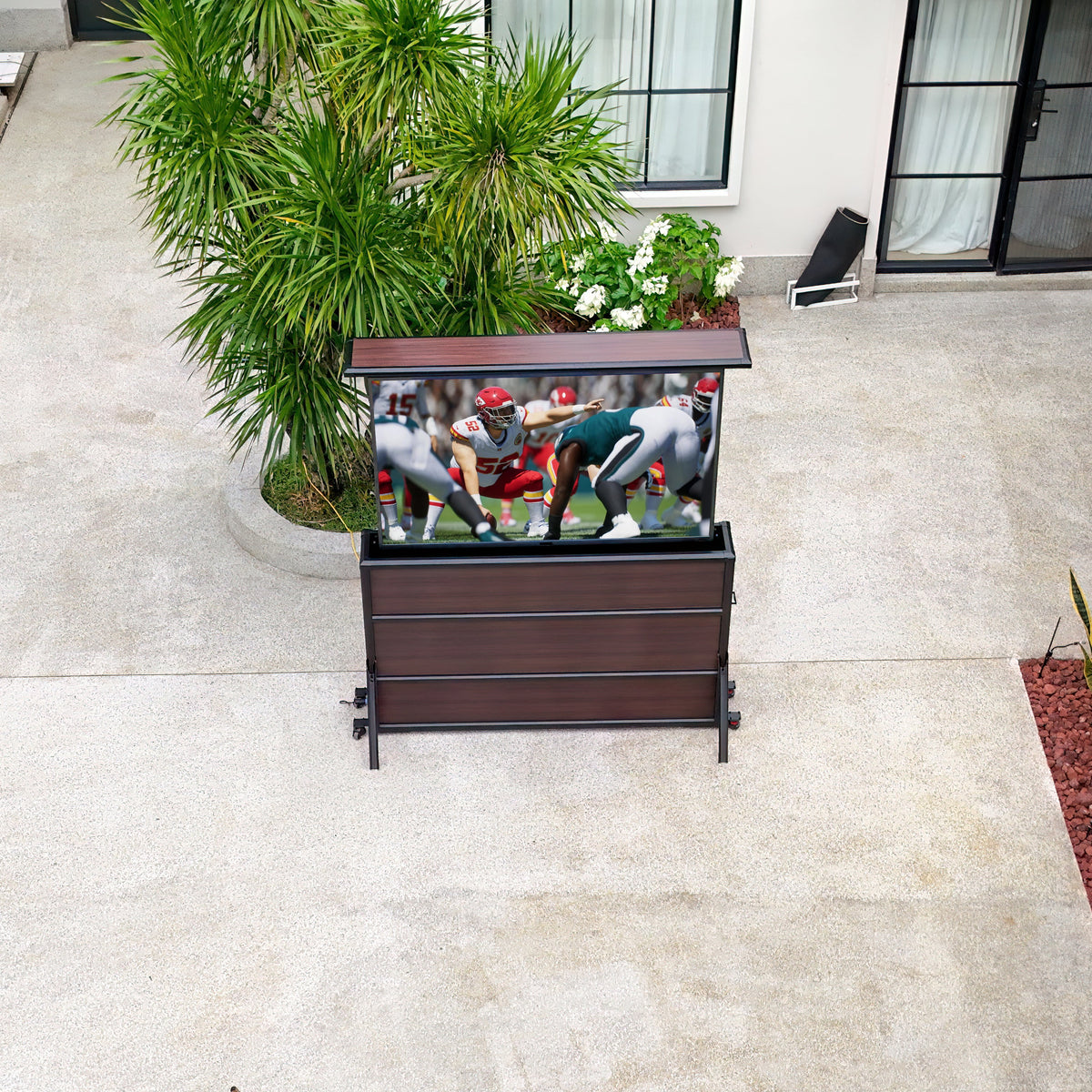 Outdoor TV lift cabinet in a backyard theater setup